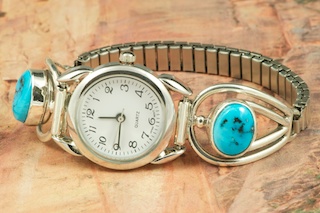Genuine Sleeping Beauty Turquoise set in Sterling Silver Watch Tips.  Ladies quartz watch with expandable watch band. Created by Navajo Artist Larson Lee. Signed.
